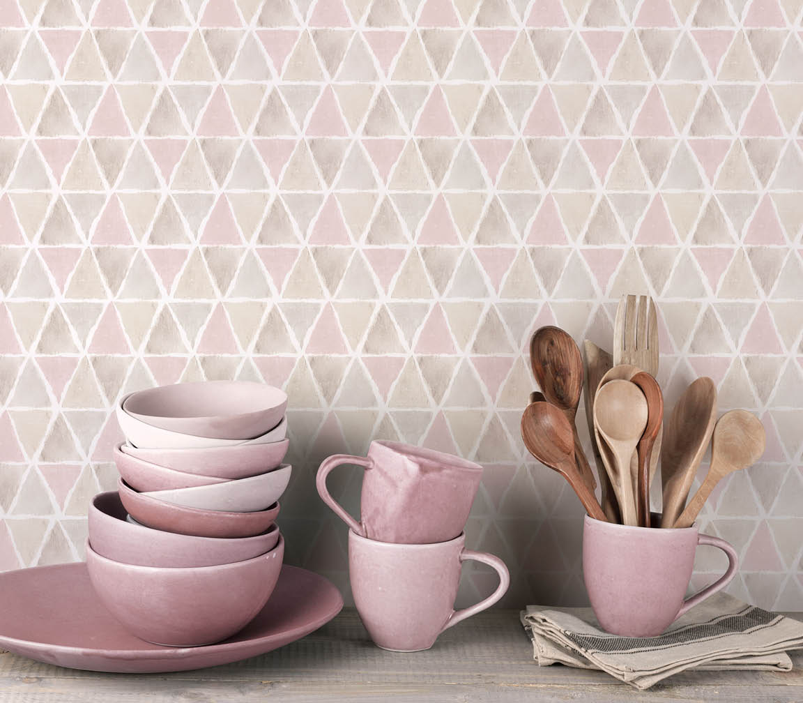 Counter with plates, bowls and cups and triangles in browns, greys and pink wallpaper