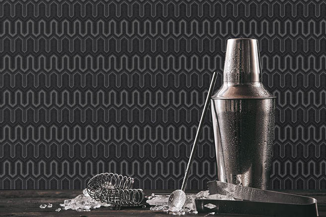 Close up of martini shaker and tools with black and silver zig zag design wallpaper
