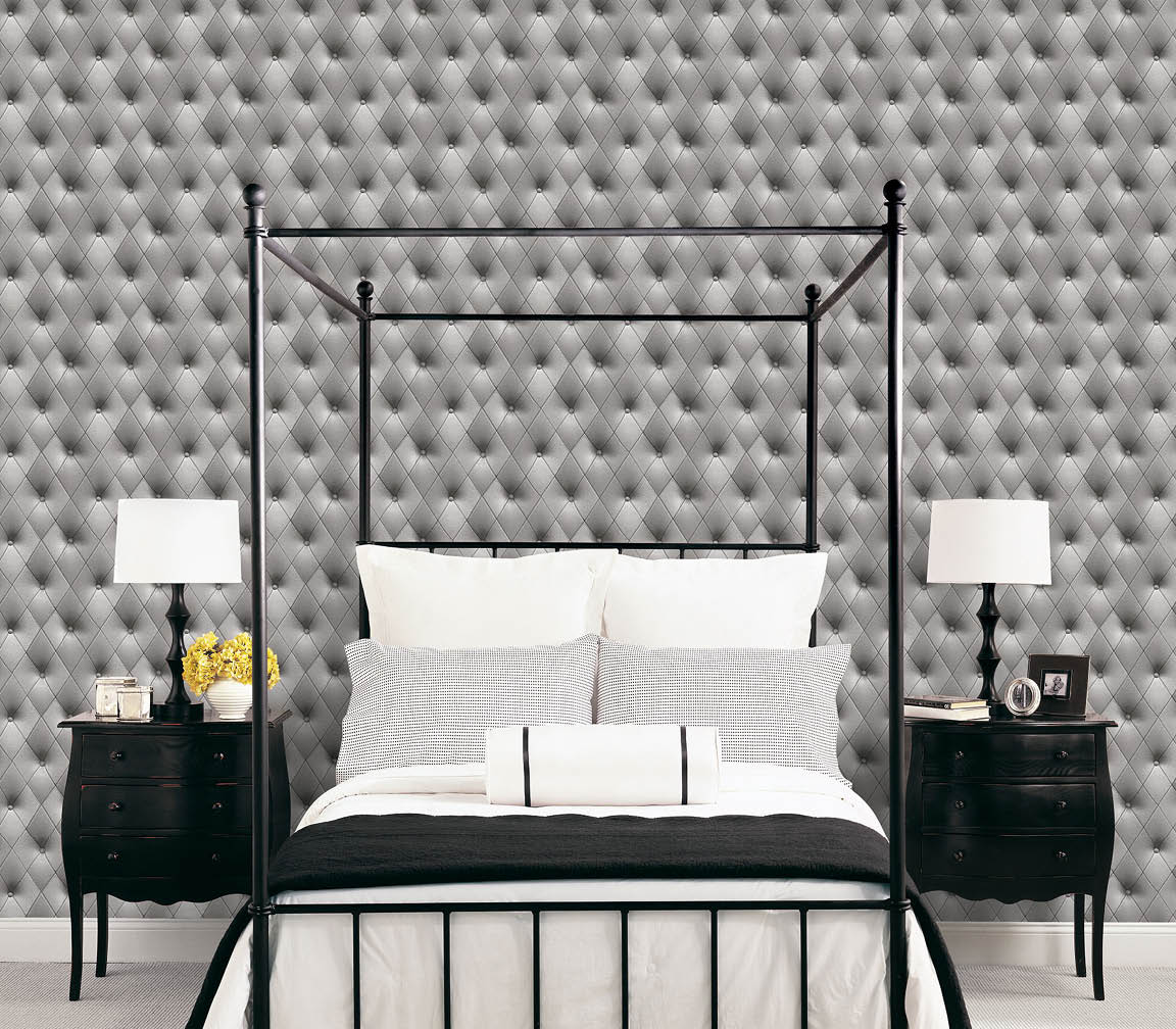 Bedroom with a buttonback in black and grey wallcovering