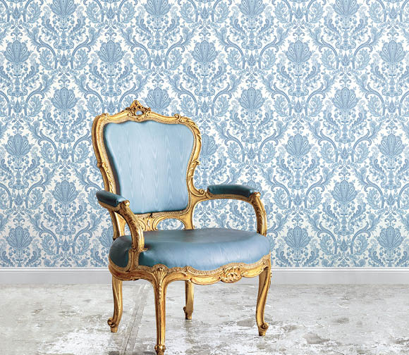 Ornate chair with blue and white silks damask wallpaper