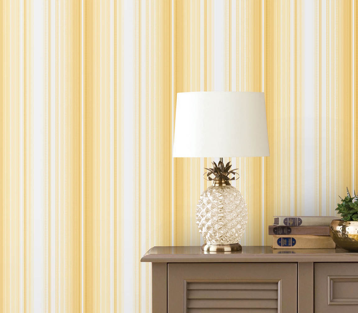 Table with pineapple lamp and yellow striped wallpaper