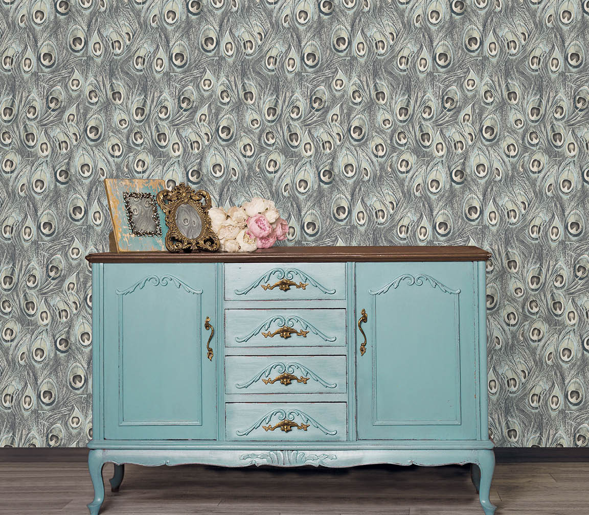 ornate cupboard with drawers and doors with blue and grey peacock feathers wallpaper
