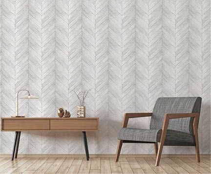 Modern living room with wooden side table and armchair with grey wood in a chevron pattern wallpaper