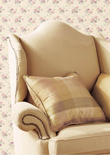 a chair and table vignette with small floral wallpaper in cream pink and green