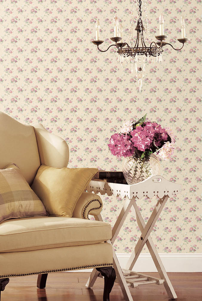 a chair and table vignette with small floral wallpaper in cream pink and green