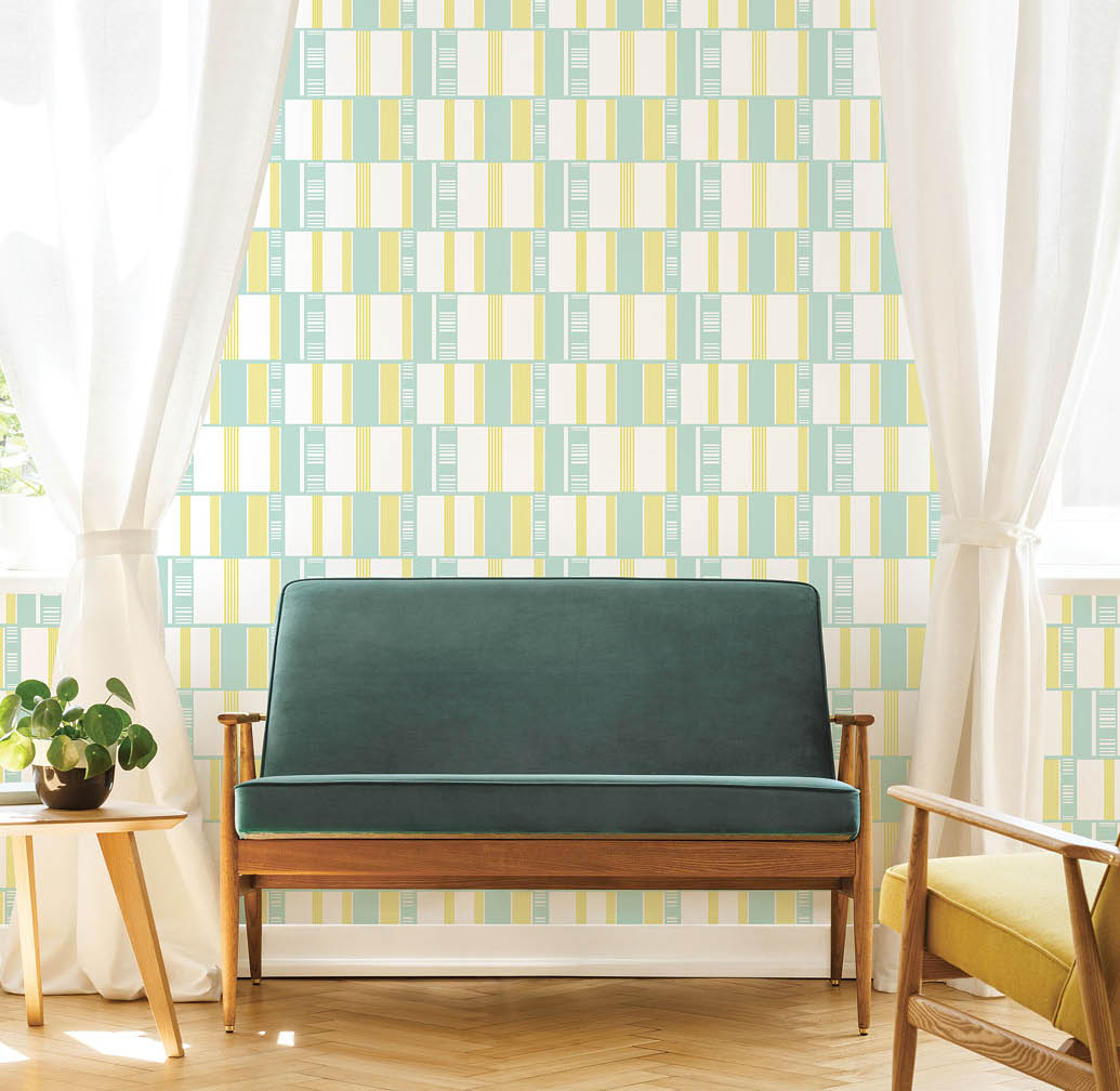 Real photo of a mid-century living room interior with a sofa, coffee table, windows and painting with retro geometric wallpaper in green and yellow